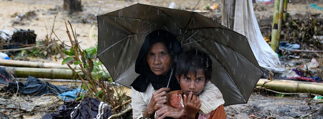 Kvinde og barn søger ly under en paraply i Bangladesh' flygtningelejr for rohingyaer Balukhali den 17. september 2017.